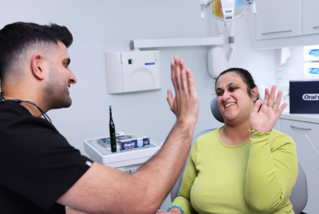 Dr Vikas Prinja with a patient in his dental practice in London, and one of the first dental professionals to become a Disability Champion through the new awards programme from Oral-B and the iADH. (Photo: Business Wire)